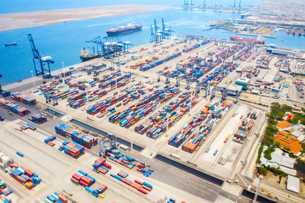 Areal view of a busy port with hundreds containers being loaded and unloaded.